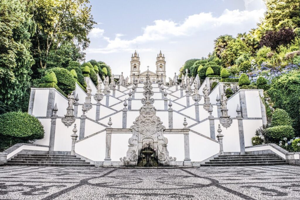 a white staircase with many statues