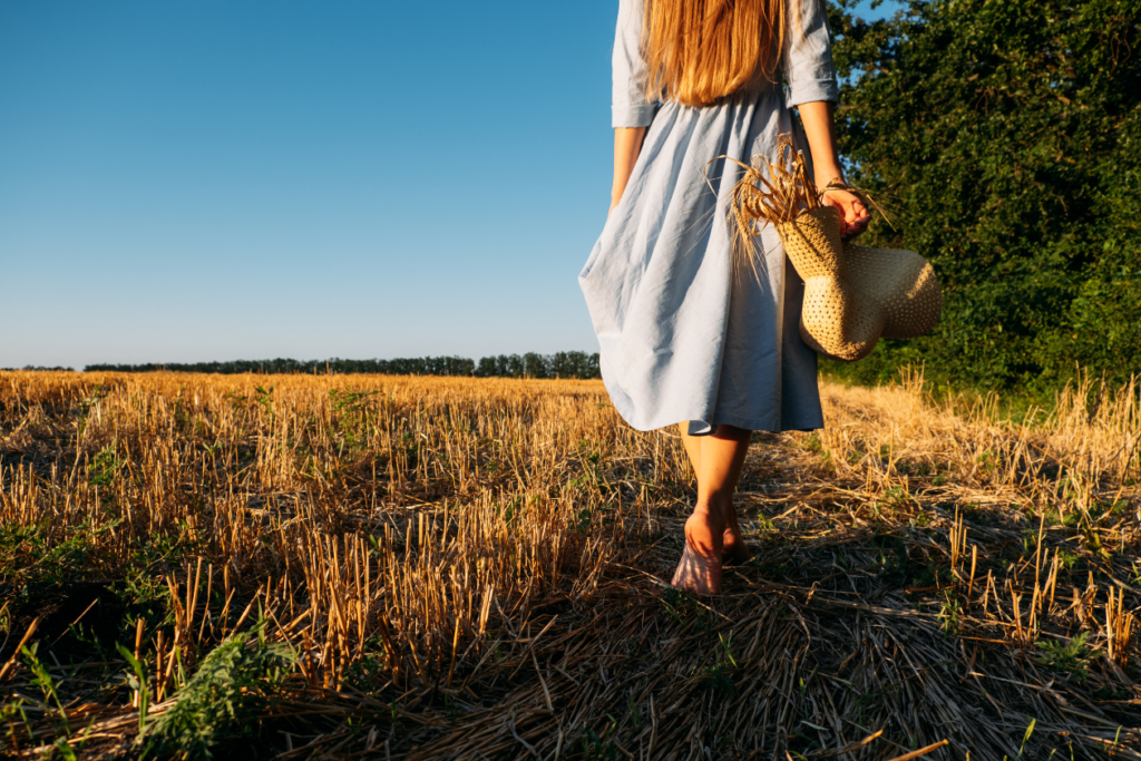 image of a person walking in a field barefoot